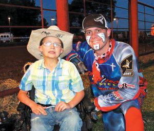 8-year-old super fan Carson with Michael Smith   - courtesy of the family